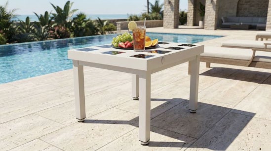 Poolside table with solar panels integrated into its top